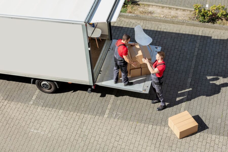 Long-distance movers loading furniture into the ruck