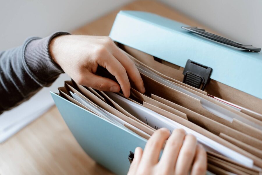 A person organizing important documents before long-distance moving