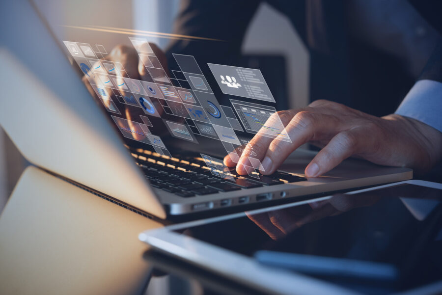 A man typing on a laptop after long-distance moving