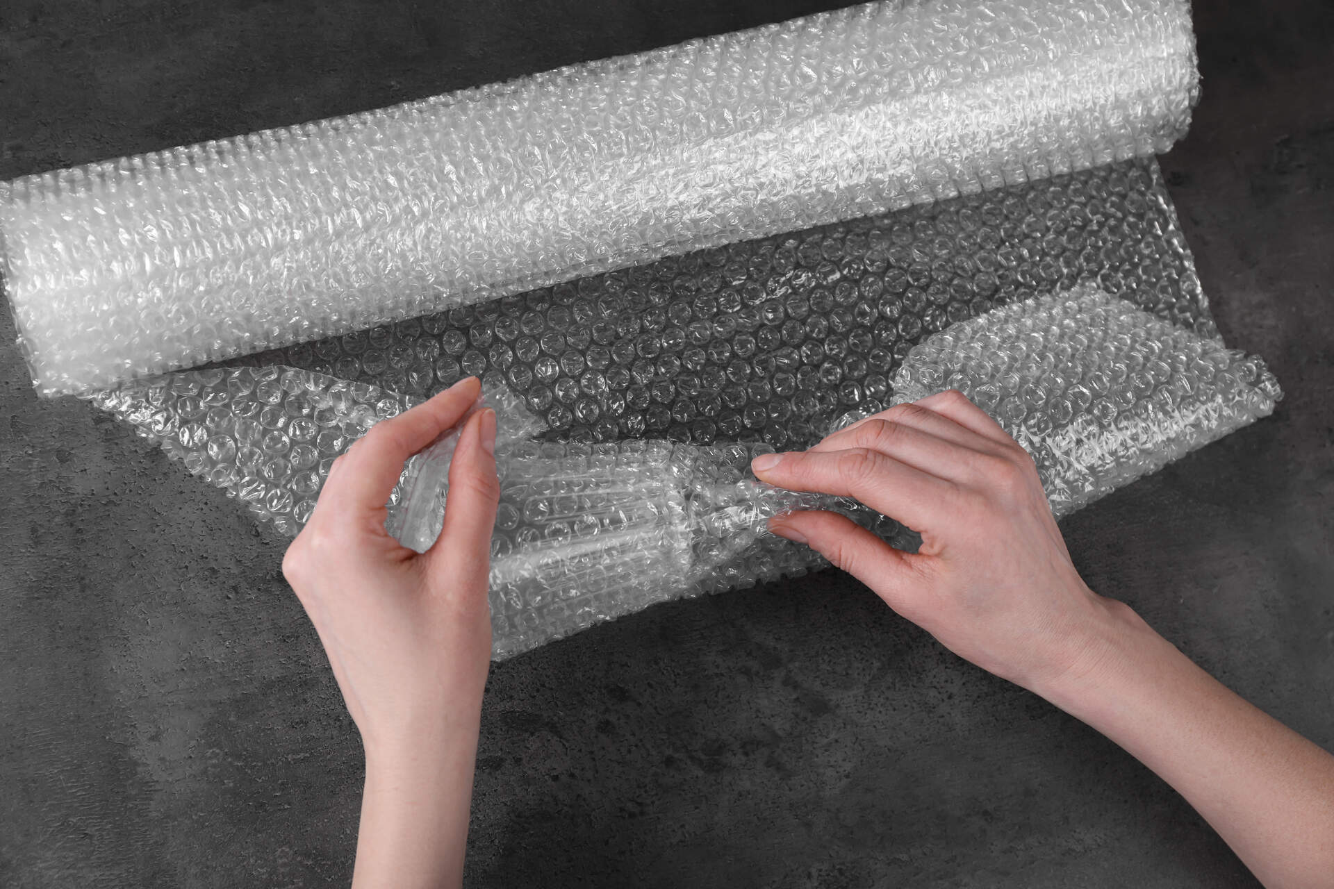 A person using bubble wrap before cross-country moving